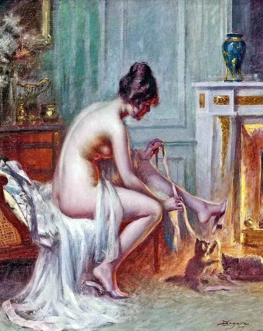 A naked woman by the fire sitting on a chair being playful with her kittens.