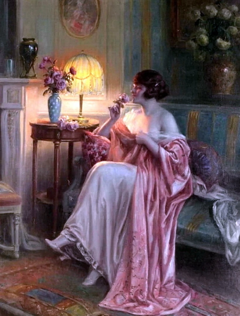 The elegant woman in a pink nighty is enjoying the lovely smell of a pink rose.