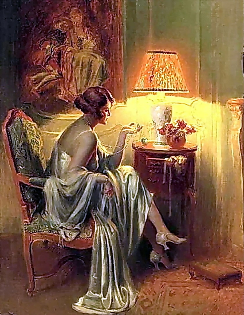 A lady is holding her pearl necklace in her hand as she sits in her nighty with flowers on the table beside her.