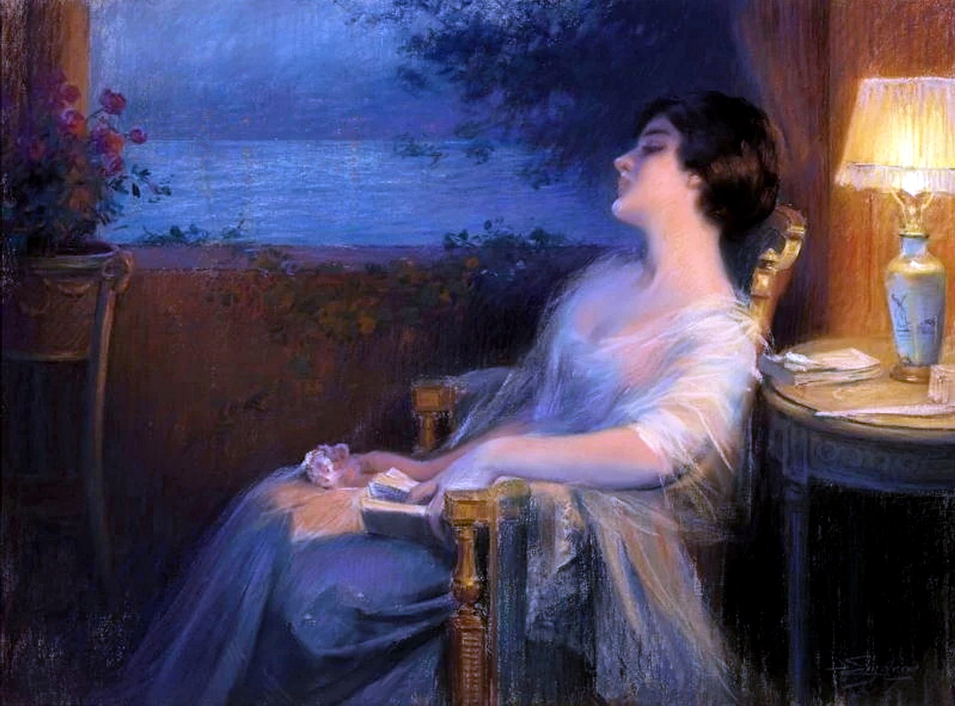 The sound of the sea has sent the woman to sleep while reading her story. The lady has a book in one hand and pink flowers in the other.