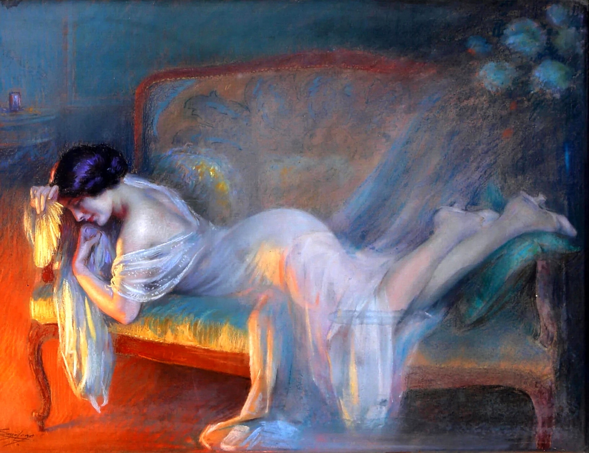 A woman is tretched out on a couch enjoying the warmth of a fire in a light pink night gown.