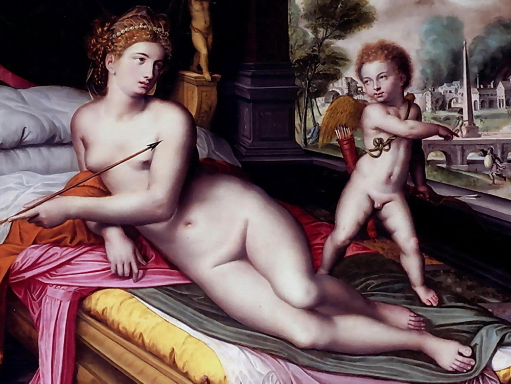 A nude Venus is holding one of Cupids arrows as she lies on her bed.