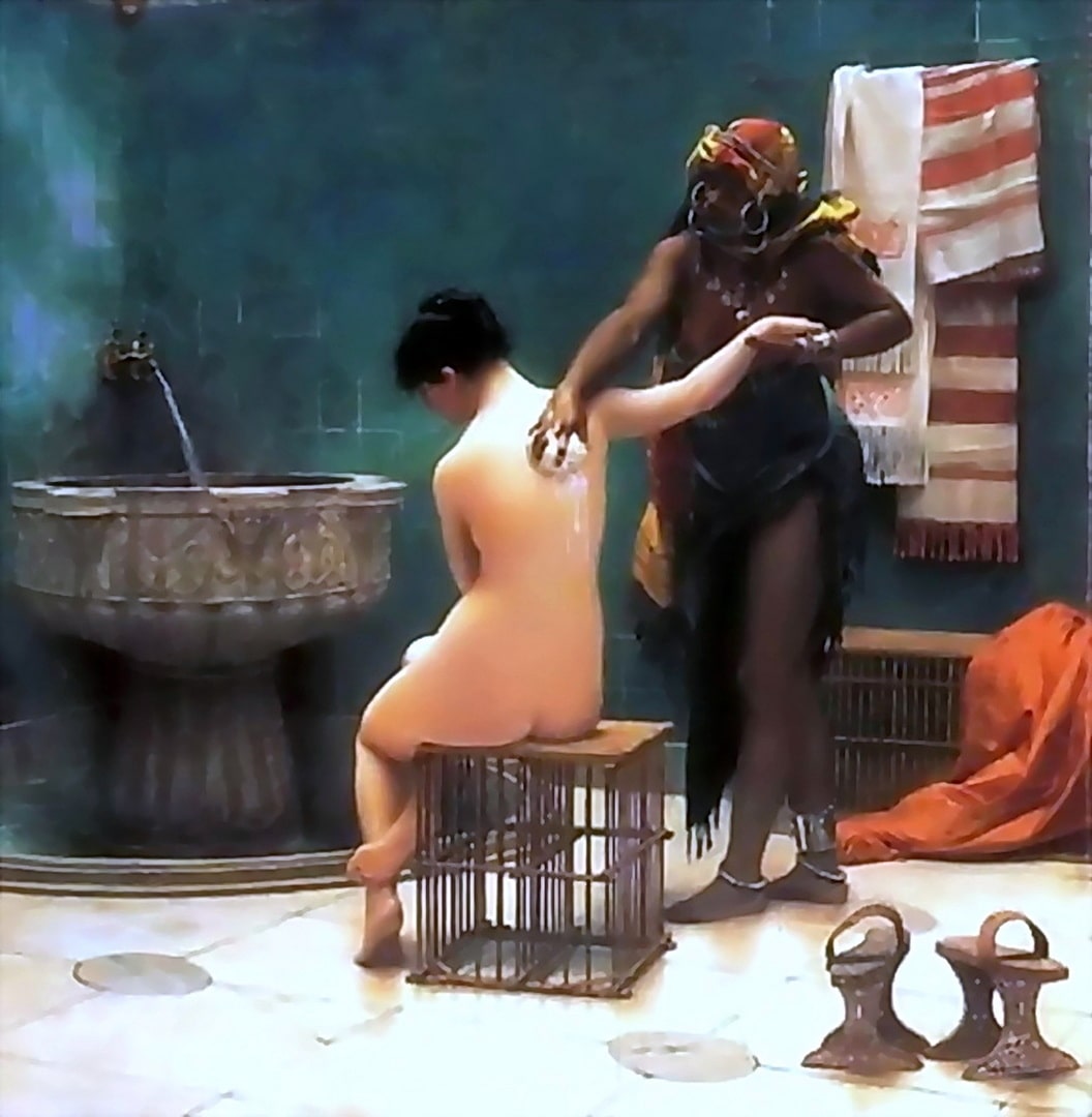 One of the harem girls is being bathed by another woman.