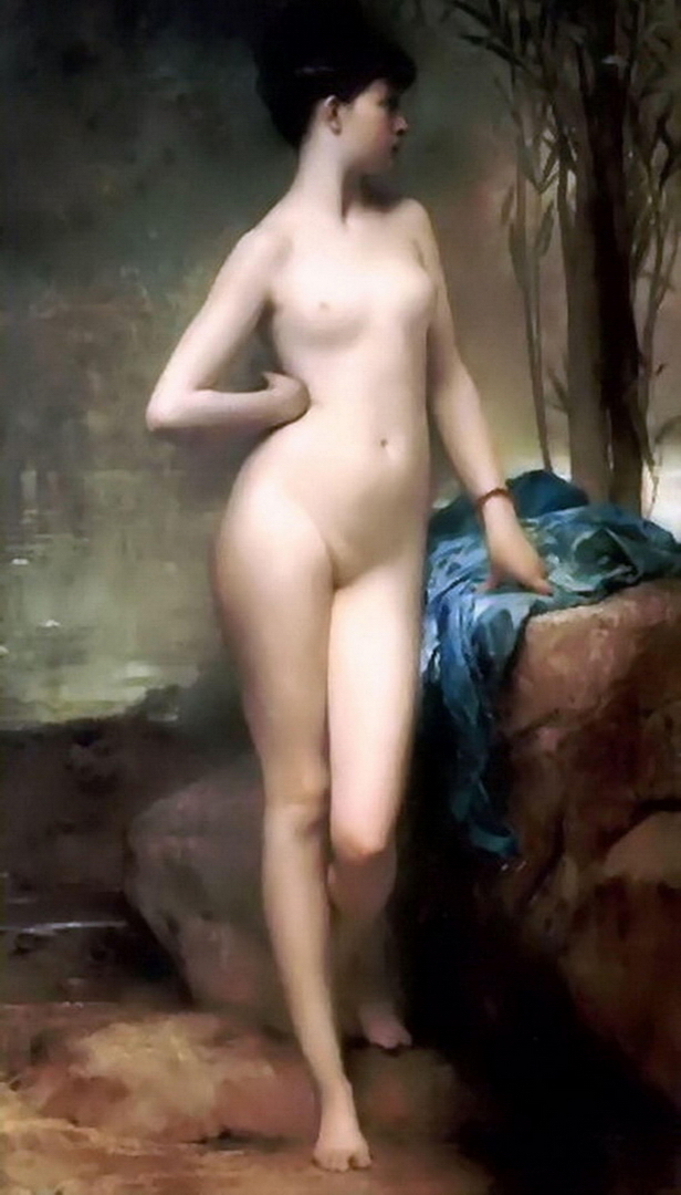 A naked lady standing with her hand on her hip. The nude girl is showing off her bosoms.