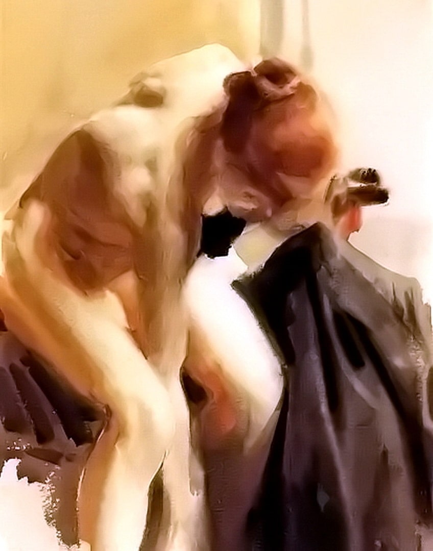 A naked girl with red hair is holding a mans coat and leaning over looking at something on the floor.